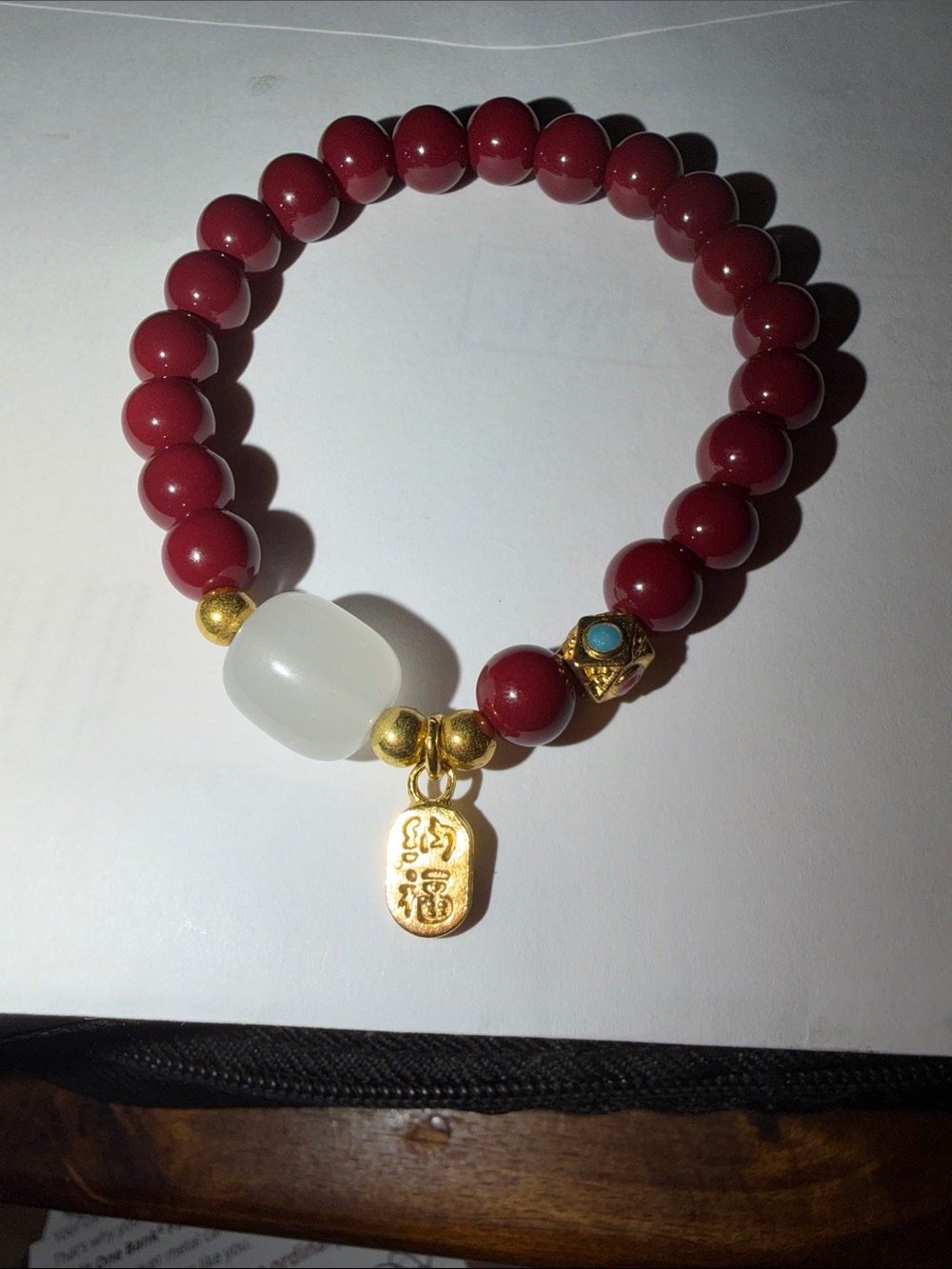 Red Bead Stretch Bracelet with White Accent and Gold Charm